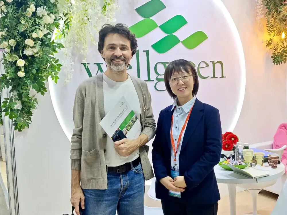 A Wellgreen team member actively discusses ingredient specifications and applications with a group of international attendees at the booth. A Wellgreen team member actively discusses ingredient specifications and applications with a group of international attendees at the booth.